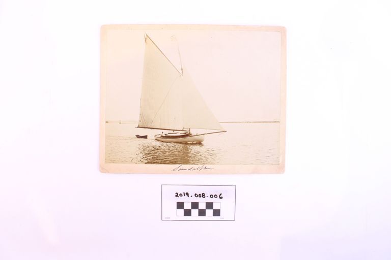 Sailboat Sandalphon Under Sail off Burlington Breakwater Towing a Skiff