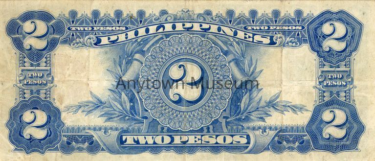The image depicts the back of a vintage two-peso currency bill from the Philippines. The bill is a light, cream color with blue designs. At the center, a large numeral "2" is prominently displayed within an elaborate circular frame that is set against a leafy vine and plaque. The words "TWO PESOS" appear in banners above and below the central design, with additional "2" numerals in varying decorative frames at each corner.
