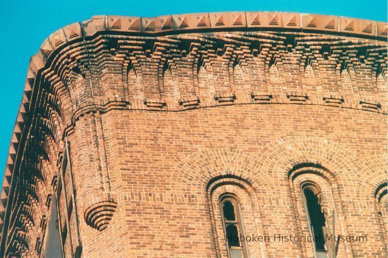 Digital image of color photo of an exterior detail at the top of a tower at the former Hudson & Manhattan Rail Road powerhouse, Jersey City, Nov., 199 picture number 1