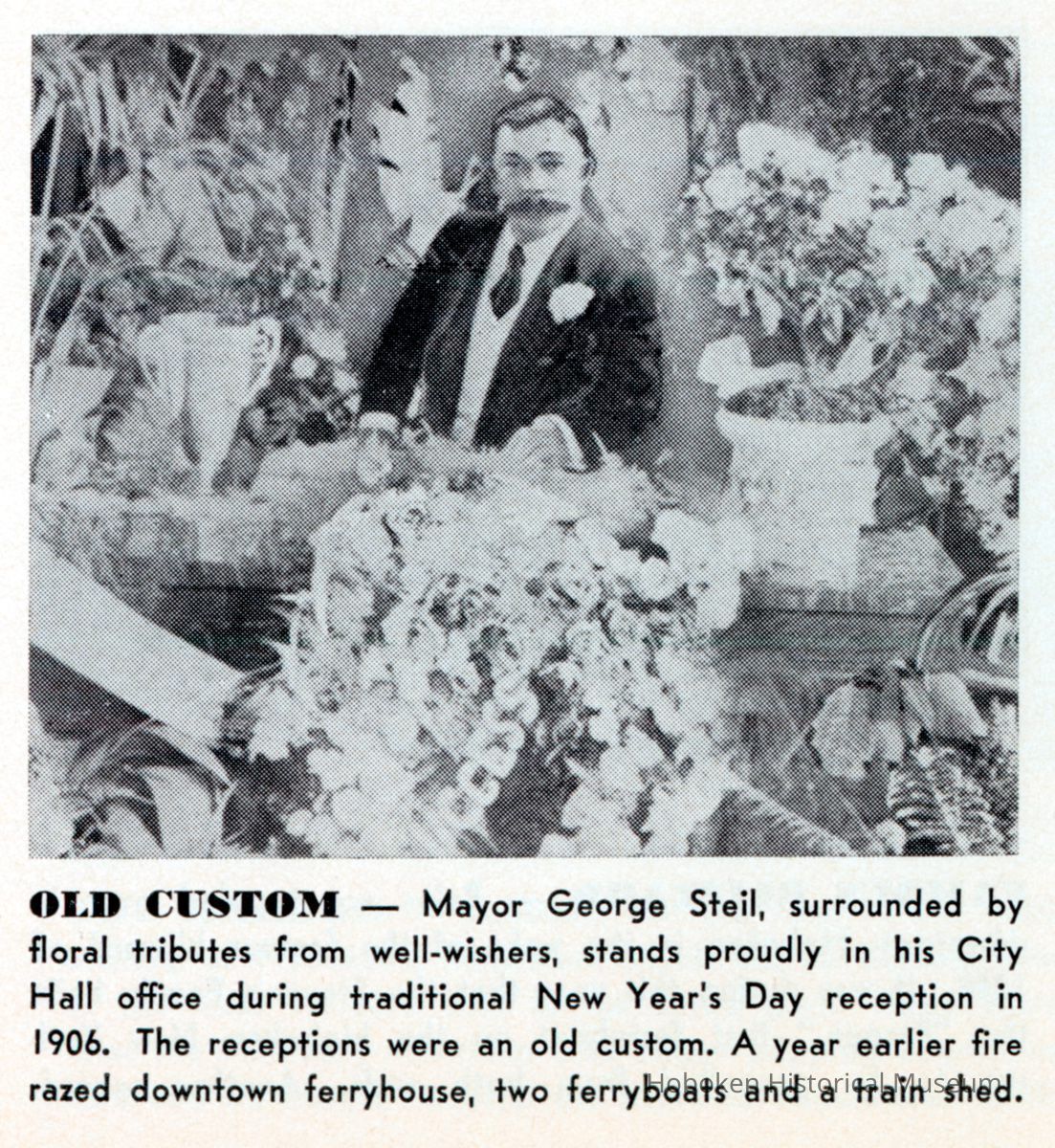 Reference image: Mayor George Steil surrounded by floral tributes from well wishers in Hoboken City Hall office, Hoboken, Jan. 1, 1906. picture number 1