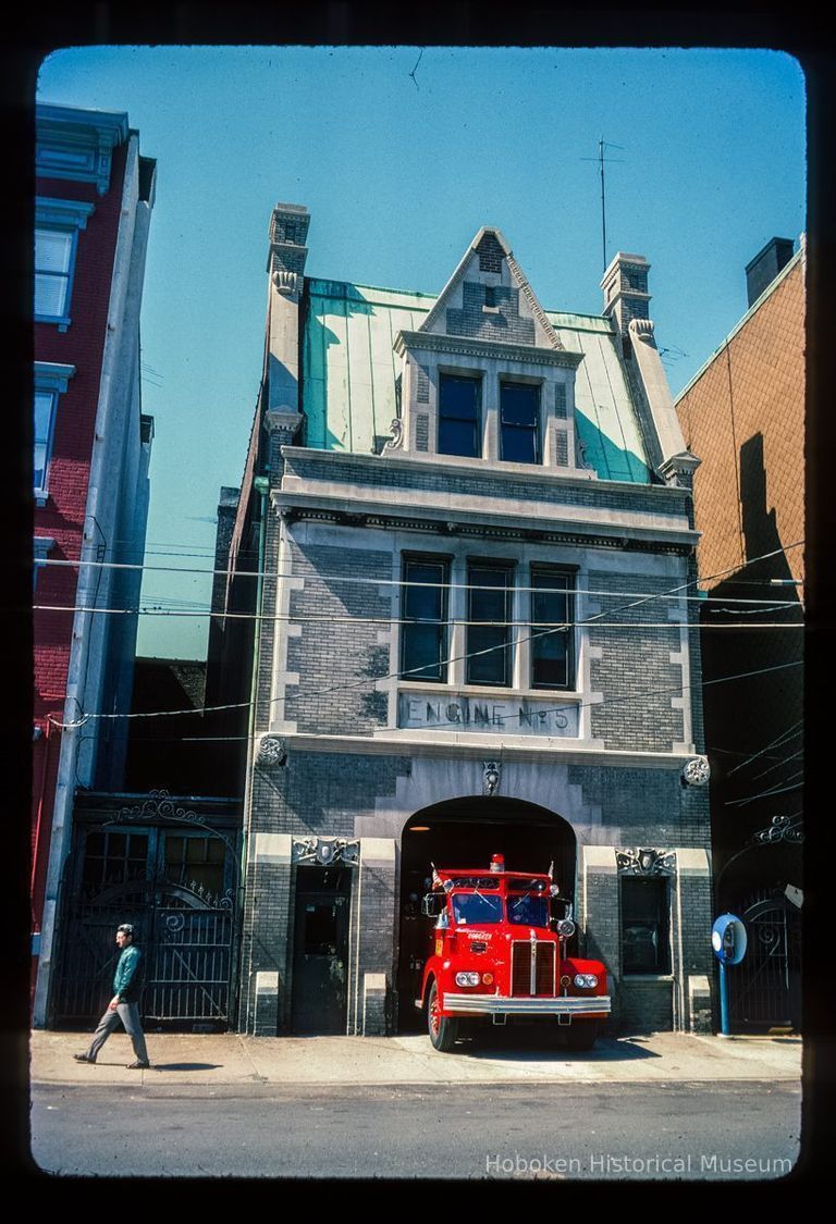 Color slide of eye-level view of the Hoboken Fire Department Engine Company No. 5 fire station façade and frieze reading 