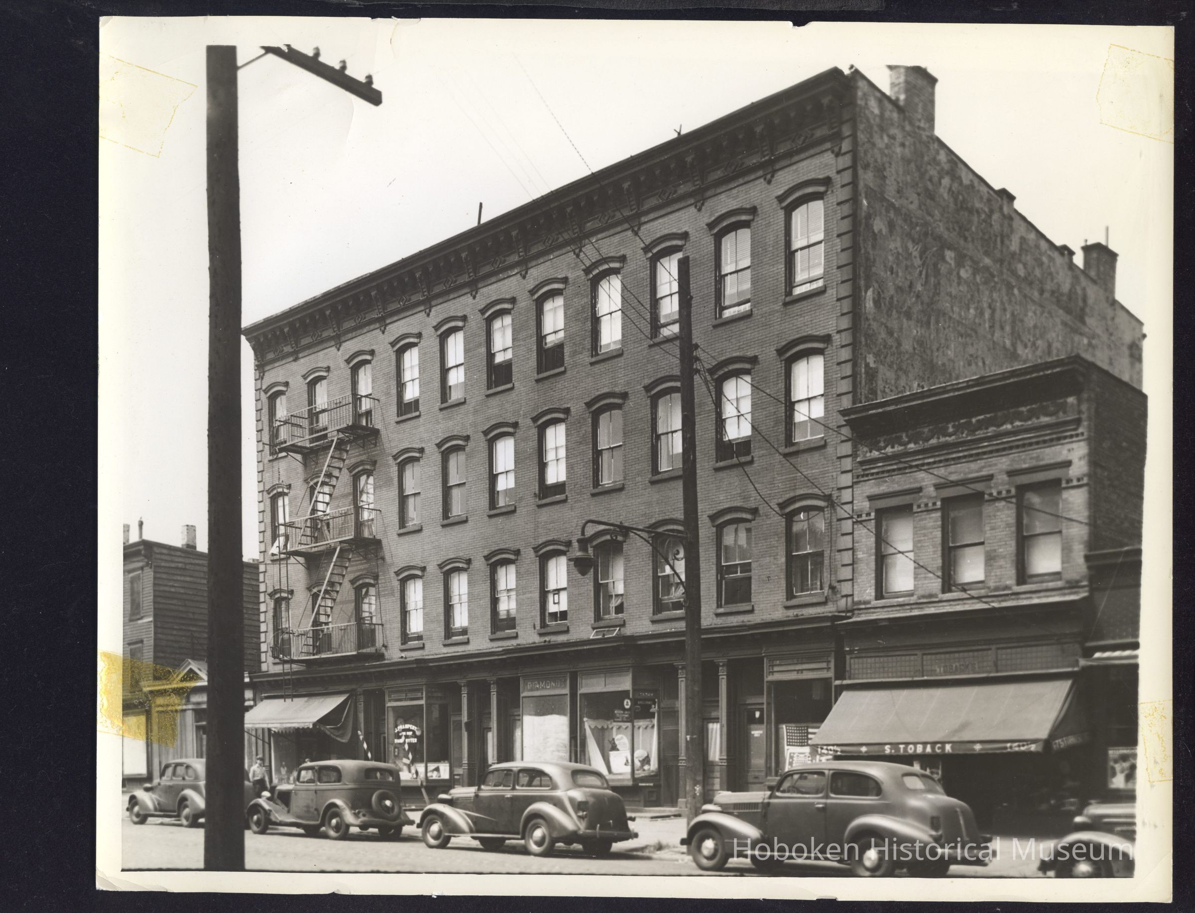 B&W photo of mixed-use row house apartment building at 142-146 Pavonia Avenue, Jersey City. picture number 1