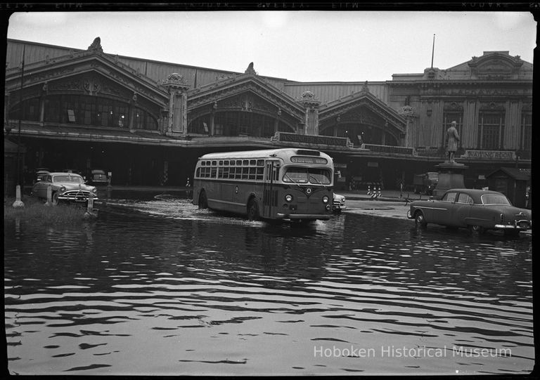 1: bus and automobiles in a flooded Lackawanna Plaza