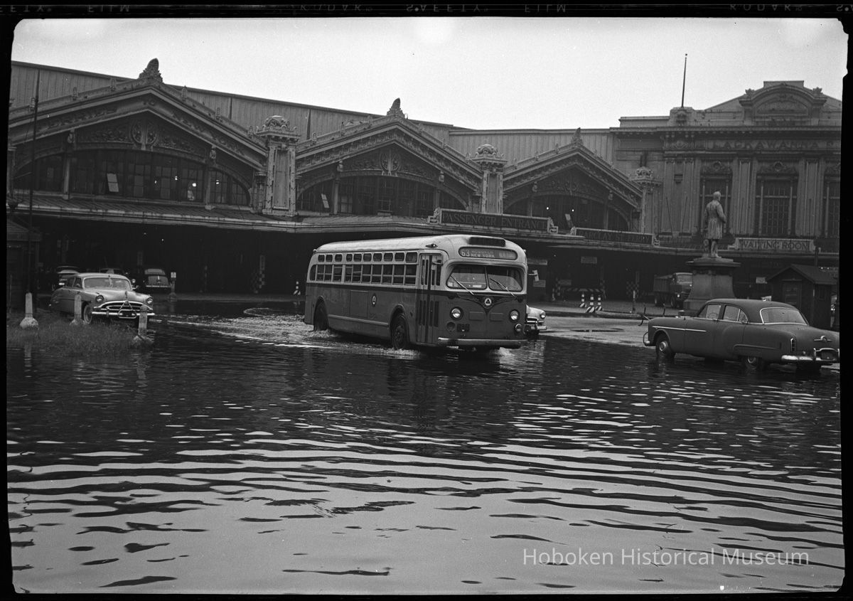 1: bus and automobiles in a flooded Lackawanna Plaza
