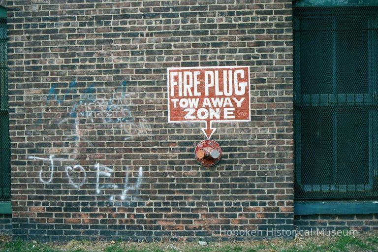 Color photo of a fire standpipe and painted wall sign of 722 Grand St., Hoboken, Jan. 3 & 4, 2002. picture number 1