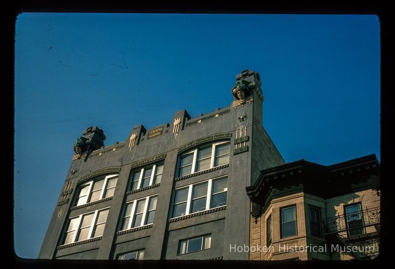 Color slide of close-up view of roofline ornamentation and upper floor windows at 70 Hudson Street and the cornice of 72 Hudson Street on the NW corner of Hudson Place picture number 1