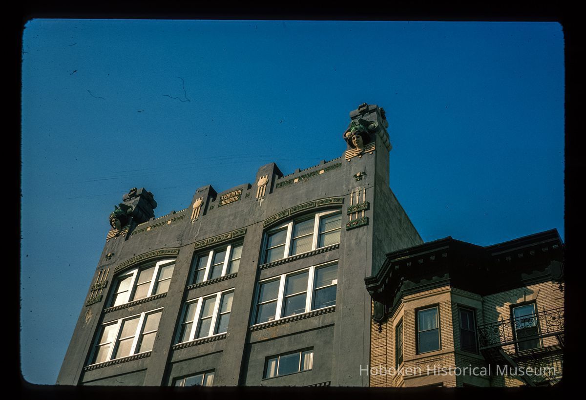 Color slide of close-up view of roofline ornamentation and upper floor windows at 70 Hudson Street and the cornice of 72 Hudson Street on the NW corner of Hudson Place picture number 1