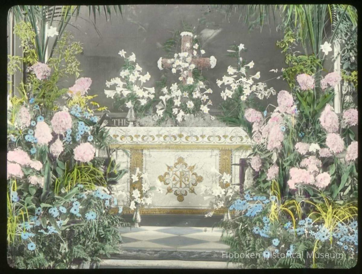 Lantern slide, color, of a church interior with floral decorations, used for promotional display in Hoboken, no date, ca. 1920. picture number 1