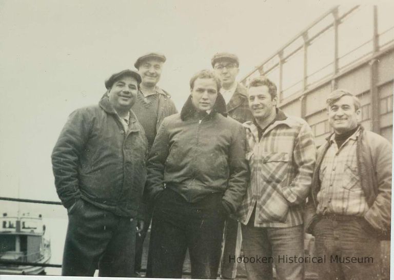 center: Marlon Brando; other actors and extras near Pier C