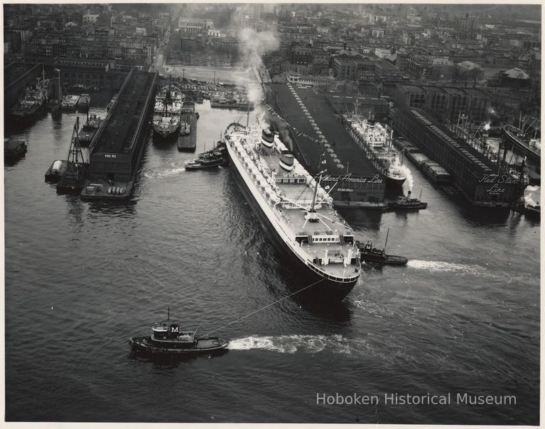 B+W aerial photo of S.S. New Amsterdam departing Holland America Lines Fifth St. Pier, Hoboken, n.d., ca. 1952-1953. picture number 1