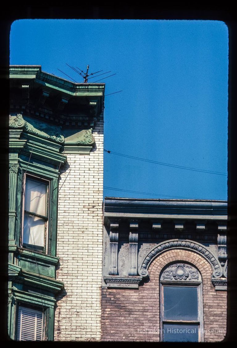 Color slide of detail view of cornices, dentils, brackets, friezes, bay windows and window heads at 1124 and 1126 Washington on the SW corner with 12th picture number 1