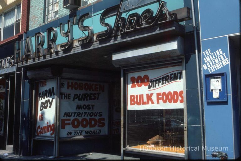 Color slide of the former storefront of Harry's Shoes,128 Washington St.; window sign announcing 