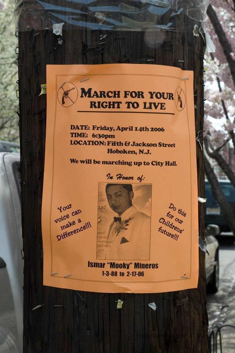 Color photo of poster on pole announcing march in honor of Ismar 