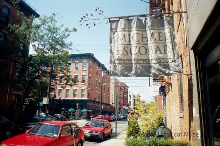 Color photo of hanging banner sign and store window for Michael Escobar, 303 Third St., Hoboken, Sept., 1-5, 2001. picture number 1