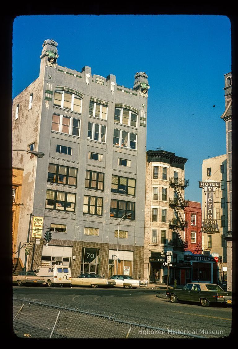 Color slide of eye-level view of facades of the Terminal Building at 70 Hudson Street, the Hotel Edwards at 72 Hudson, and the Hudson Spa at 74 Hudson on the NW corner of Hudson Place picture number 1