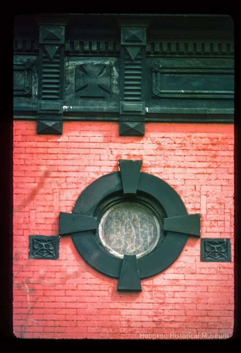 Color slide of close-up view of oculi window, decorative tile and cornice at 1100 Bloomfield on the NW corner with 11th picture number 1