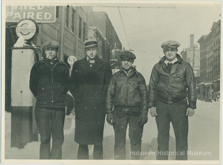 B+W photo of 4 men posed in the winter in front of the Model Garage, 214 Clinton St., Hoboken, no date, ca. 1927. picture number 1