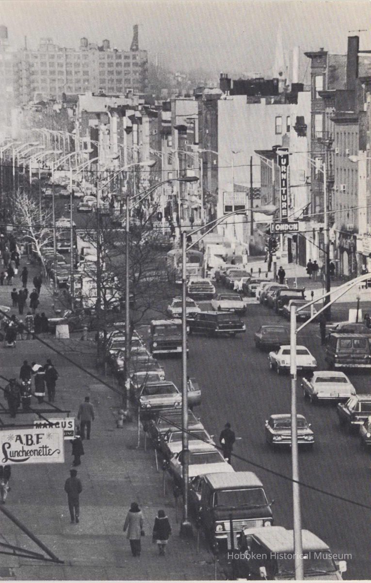 Reference image of printed photo image of view N on Washington St. from First St. from pg [35] of archives catalog 2002.026.0002, Hoboken, ca. 1975. picture number 1