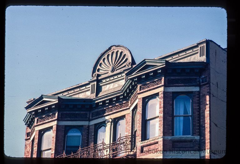 Color slide of close-up view of pediments, cornice, bay windows and fire escape at 106 11th on the NE corner with Bloomfield picture number 1