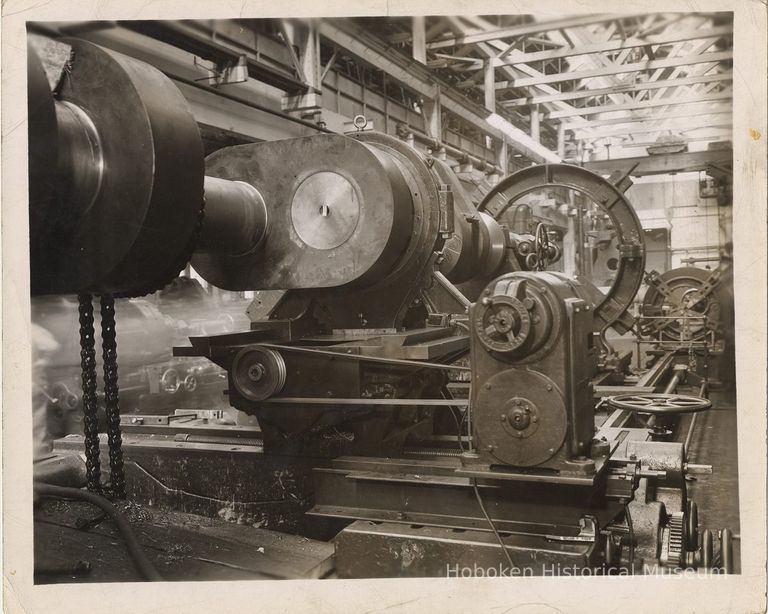 B+W photo of metal machined part (crank shaft) on lathe in machine shop, Bethlehem Steel Shipyard, Hoboken, n.d, ca. 1955-1957. picture number 1