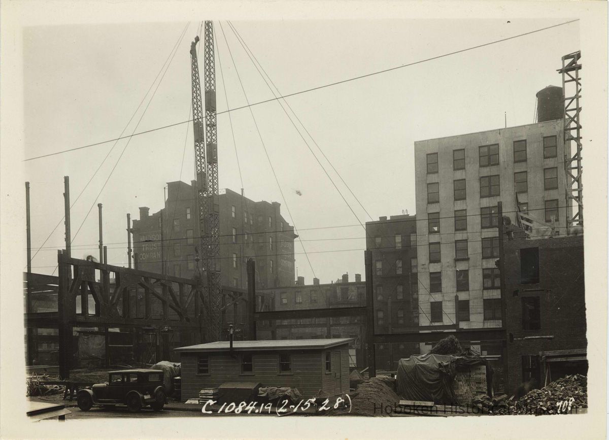 Sepia-tone photo of steel frame erection on the site for the Fabian Theatre, southeast corner of Newark & Washington Sts., Hoboken, Feb. 15, 1928. picture number 1