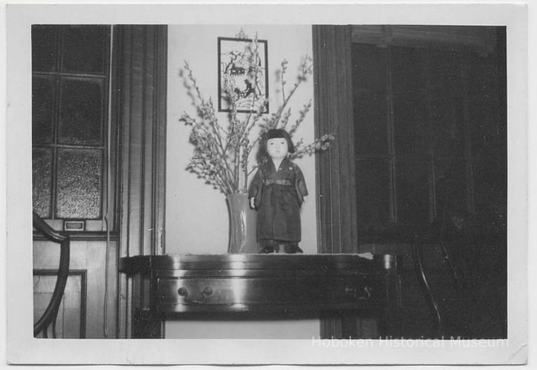 Black-and-white photo of Japanese Girl Guide doll on a table at Hoboken's Girl Scout house, Hoboken, 1951. picture number 1