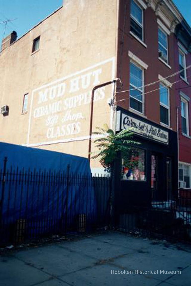 Color photo of sign for Mud Hut painted on the south wall of 416 Bloomfield St., Hoboken, Sept., 1-5, 2001. picture number 1