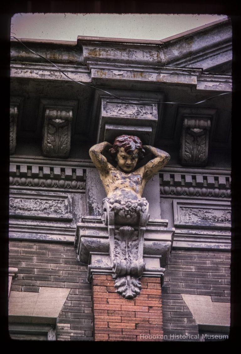 Color slide of close-up view of figurine bracket at 712 Adams between 7th and 8th picture number 1