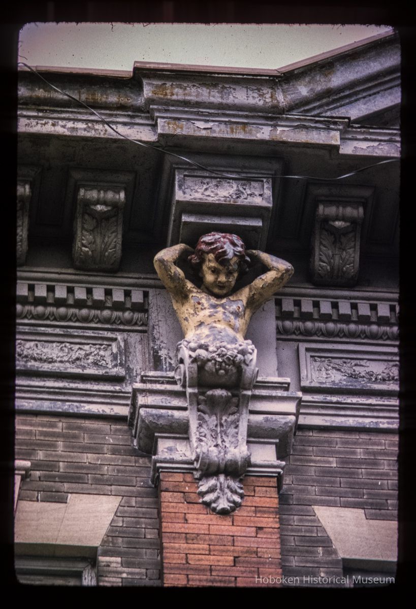 Color slide of close-up view of figurine bracket at 712 Adams between 7th and 8th picture number 1