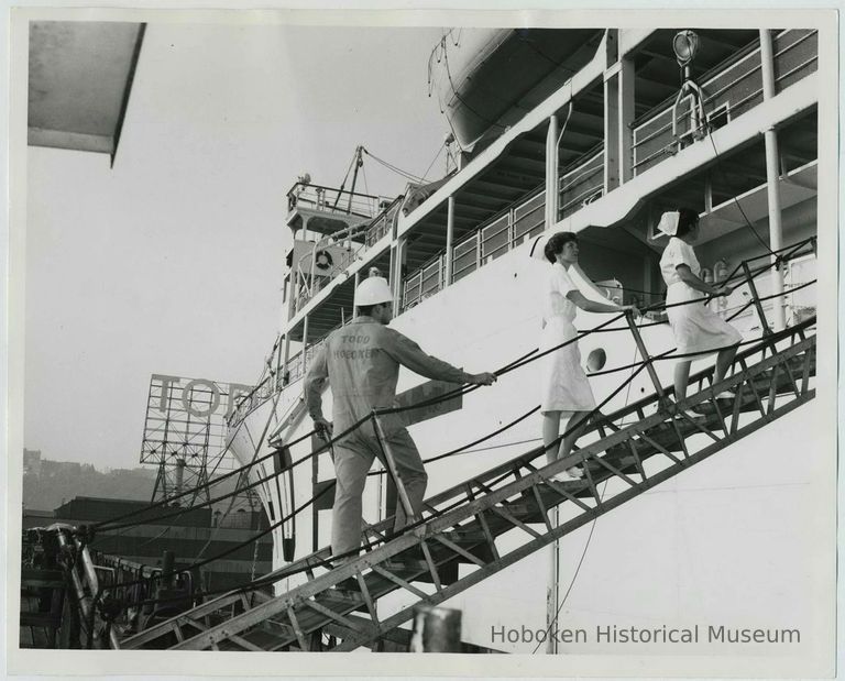 B+W photo of two nurses & Todd Shipyard engineer on gangplank of S.S. Hope, Hoboken. n.d., ca. 1960-1963. picture number 1