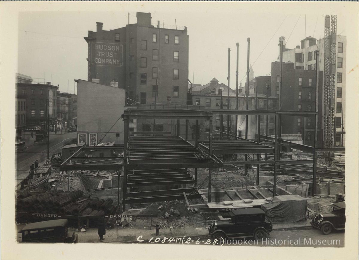 Sepia-tone photo of steel frame erection on the site for the Fabian Theatre, southeast corner of Newark & Washington Sts., Hoboken, Feb. 6, 1928. picture number 1