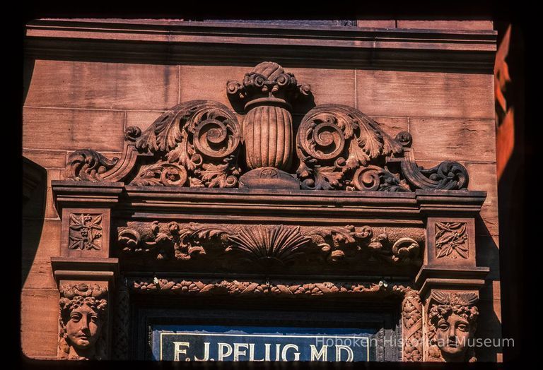 Color slide of close-up view of portico pediment and transom window signage reading 