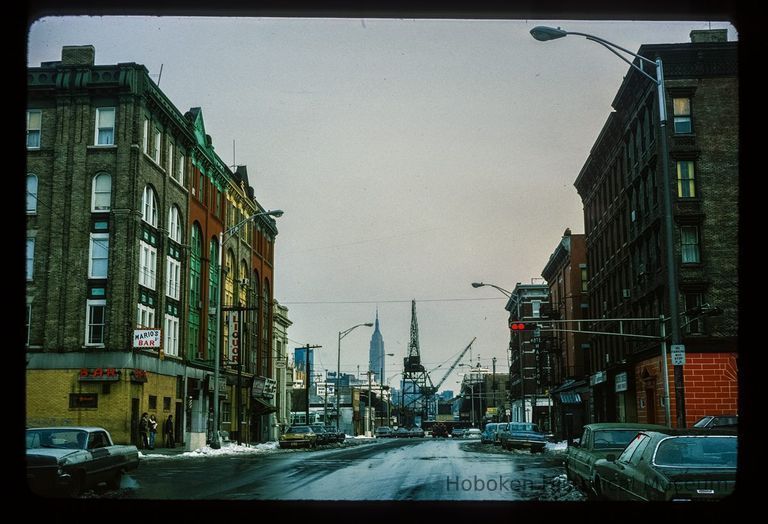 Color slide of eye-level view of row houses on 14th looking E from Bloomfield showing Mario's Bar picture number 1