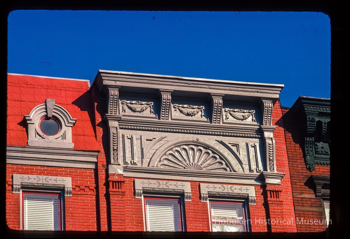 Color slide of detail view of cornice, frieze, window heads, brick pilasters and oculi window at 1123 Washington between 11th and 12th picture number 1