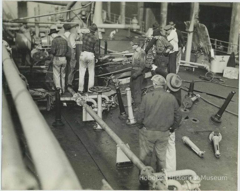 B+W photo showing workers repairing damage on the main deck on unidentified vessel at the Bethlehem Steel Shipyard, Hoboken Division, no date, ca. 194 picture number 1