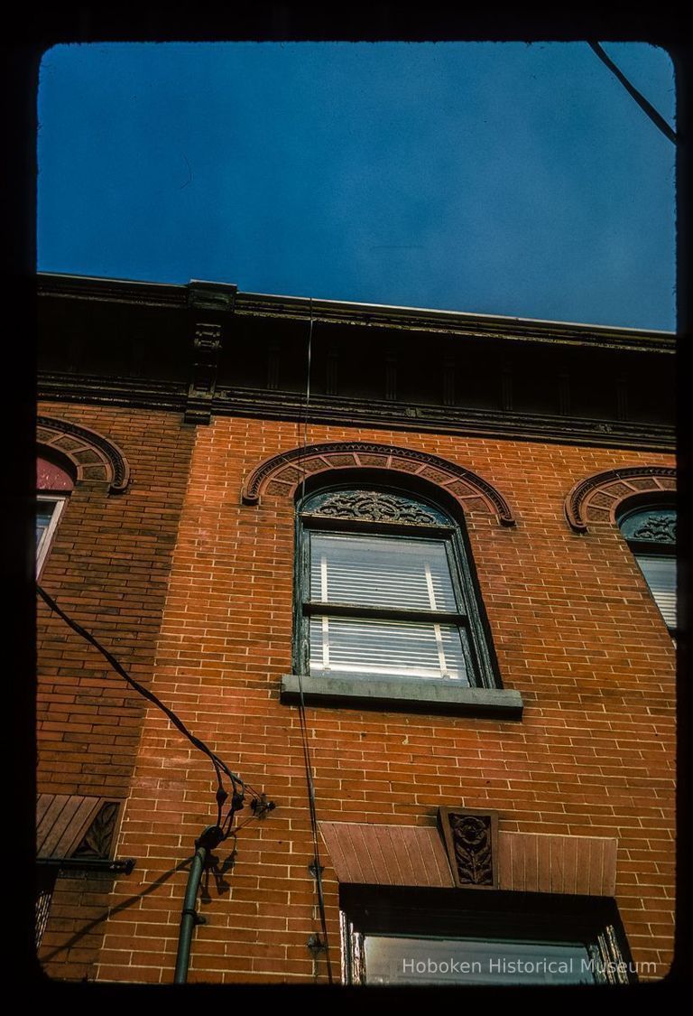 Color slide of detail view of façade, keystone, flat arch, semicircular arch and cornice of one of the buildings between 206 and 218 13th on the N side between Park and Garden. picture number 1