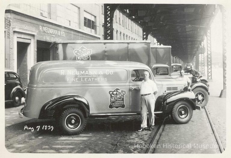 B+W photo of R. Neumann & Co. driver with trucks outside building on Ferry St., Hoboken, August 7, 1939. picture number 1