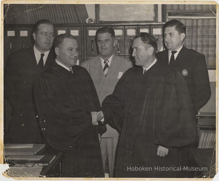 B+W photo of two judges in a handshake with three men looking on, Hoboken, no date, circa 1945-1950. picture number 1