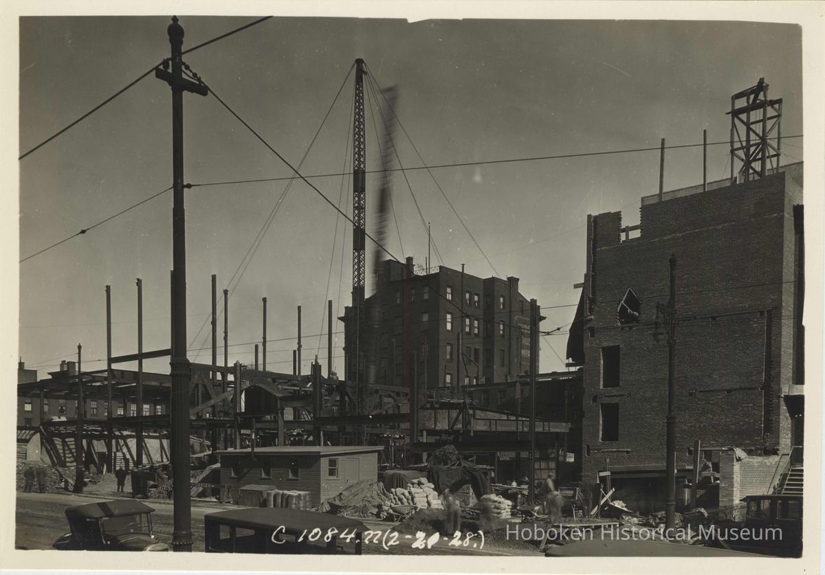 Sepia-tone photo of steel frame erection on the site for the Fabian Theatre, southeast corner of Newark & Washington Sts., Hoboken, Feb.21, 1928. picture number 1