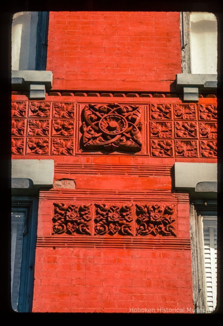 Color slide of detail view of decorative tiles and frieze at 627 Washington between 6th and 7th picture number 1