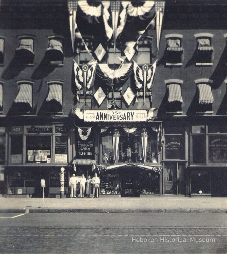 B+W photo of United Decorating Co., 421 Washington St., Hoboken on 35th anniversary, 1934, with 4 family members outside store. picture number 1