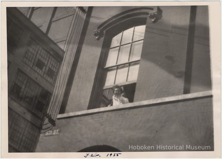 Digital image of B+W photo of Paul Millenthal leaning out a second story window, Stevens Hoboken Academy, Hoboken, February, 1955. picture number 1