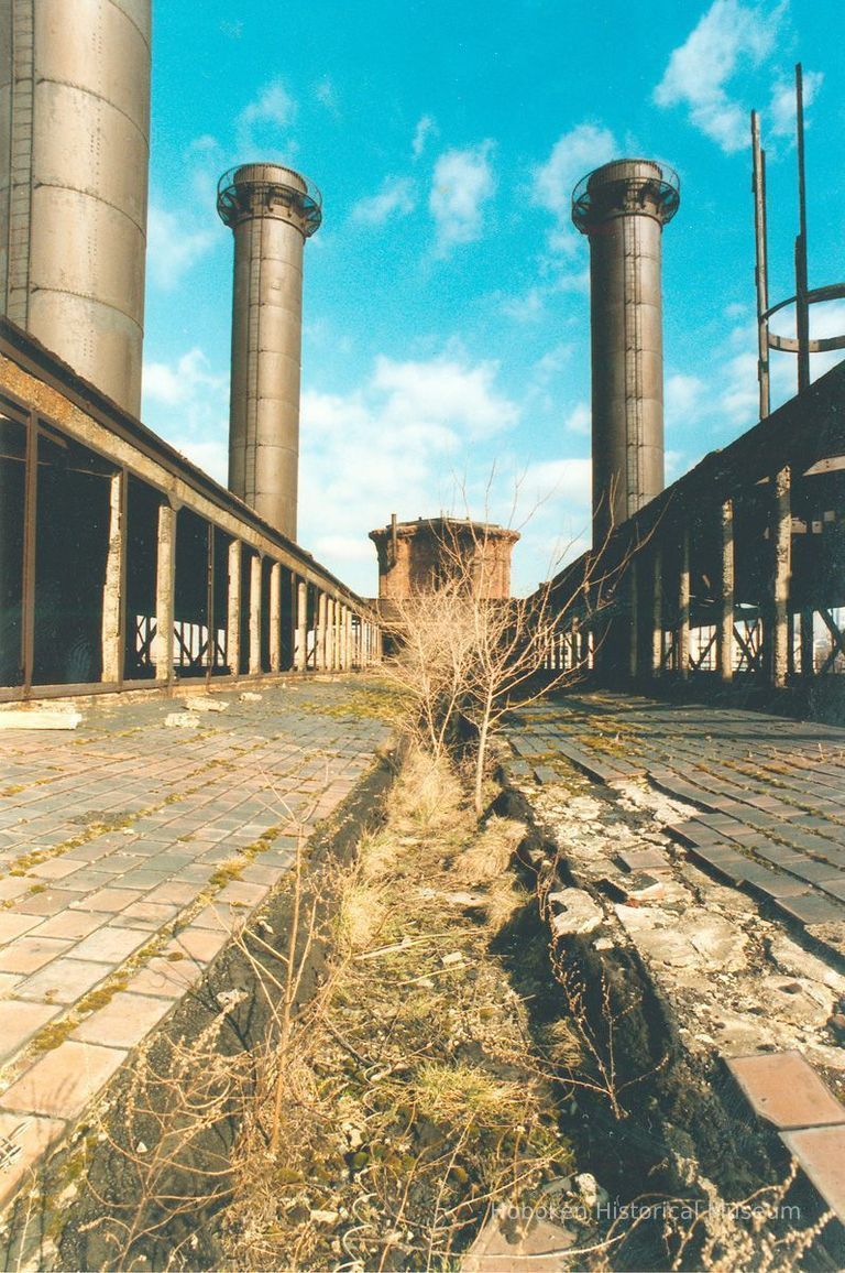 Digital image of color photo on the exterior roof with smokestacks of the former Hudson & Manhattan Rail Road powerhouse, Jersey City, March, 2000. picture number 1