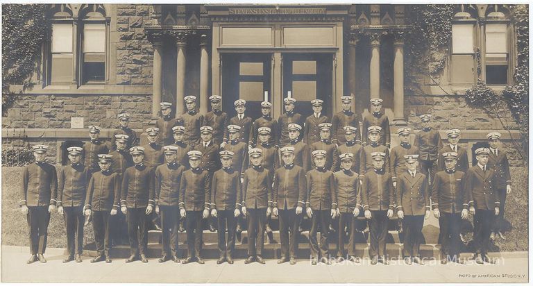 Black-and-white panoramic goup photo of Stevens Cadets posed outside a Stevens Institute of Technology building, Hoboken, no date, ca. 1910. picture number 1