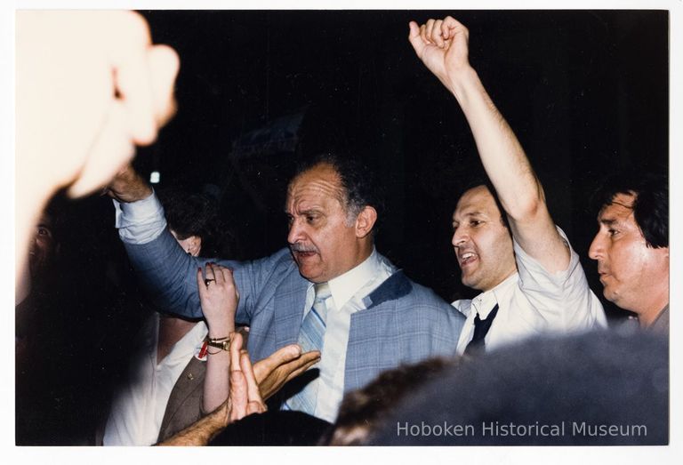 Color photo of mayoral candidate Tom Vezzetti in front of City Hall with supporters on election night, Hoboken, [June 11, 1985]. picture number 1