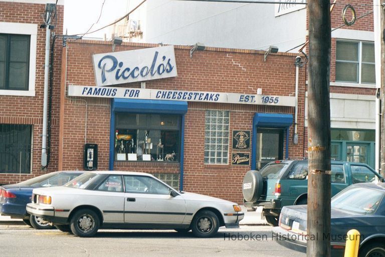 Color photo of a wall sign for Piccolo's, Famous for Cheesesteaks, Est. 1955., 92 Clinton Street, Hoboken, Jan. 3 & 4, 2002. picture number 1