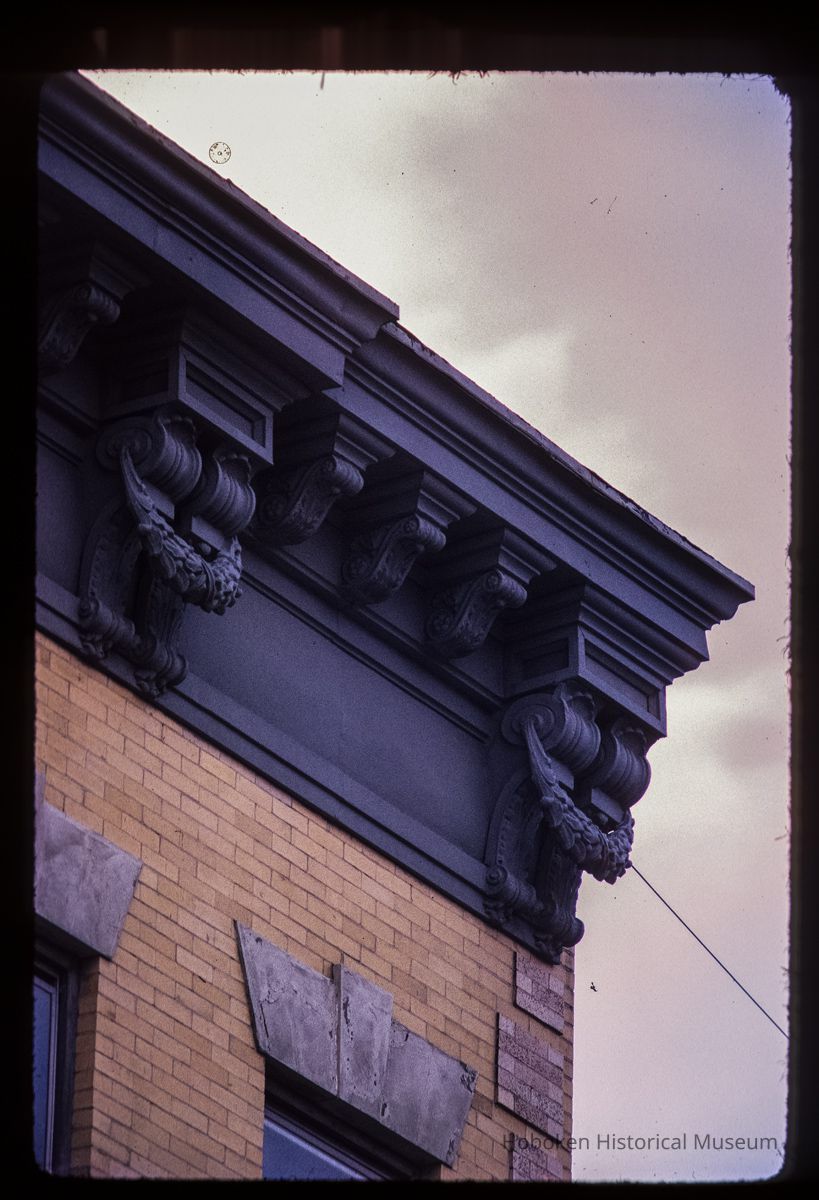 Color slide of detail view of cornice, brackets, frieze and window head at 704 Grand between 7th and 8th picture number 1