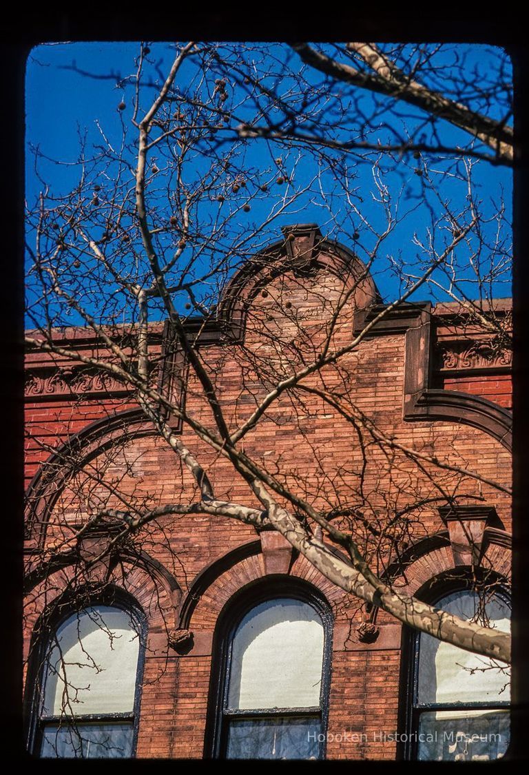 Color slide of close-up view of brick pediment, cornice, keystones and semicircular arches at 802 Hudson between 8th and 9th picture number 1