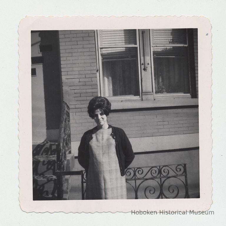 B+W photo of Donald Fontana's mother(?) posed outside building, Hoboken, n.d., ca. 1963. picture number 1