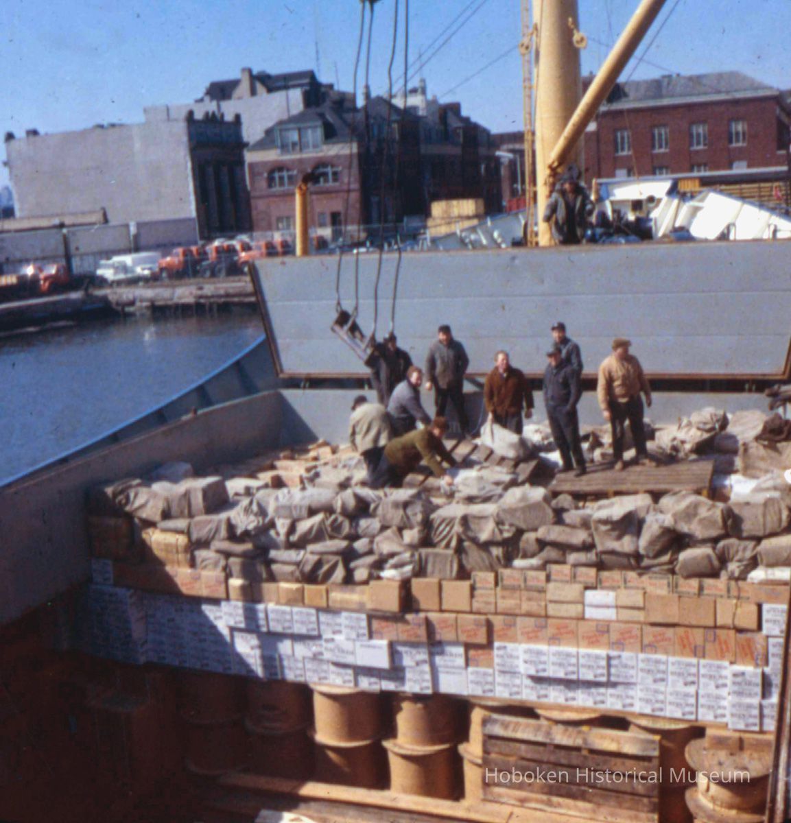 Image: color transparency of several longshoremen standing in the hold of a ship moored on the south side of Pier A, Hoboken, May, 1979. picture number 1